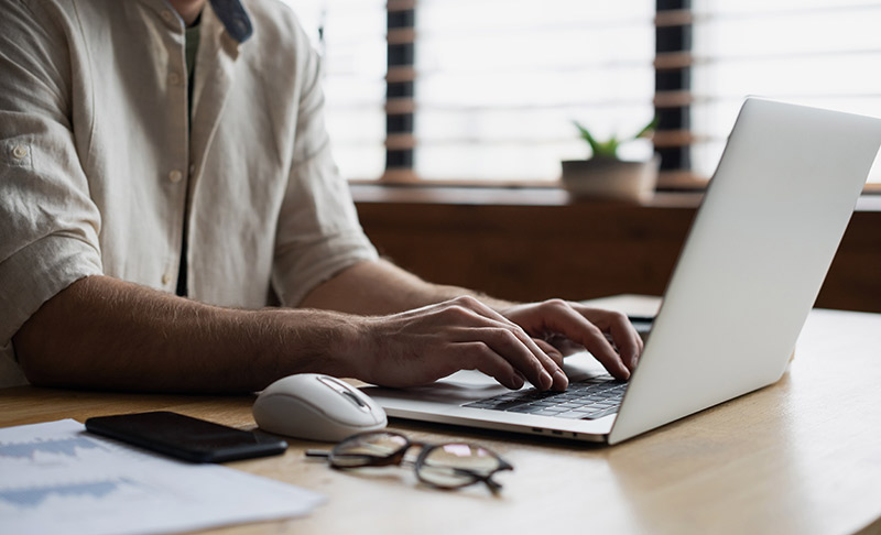 Online Protection Blog Man using computer with glasses and mouse