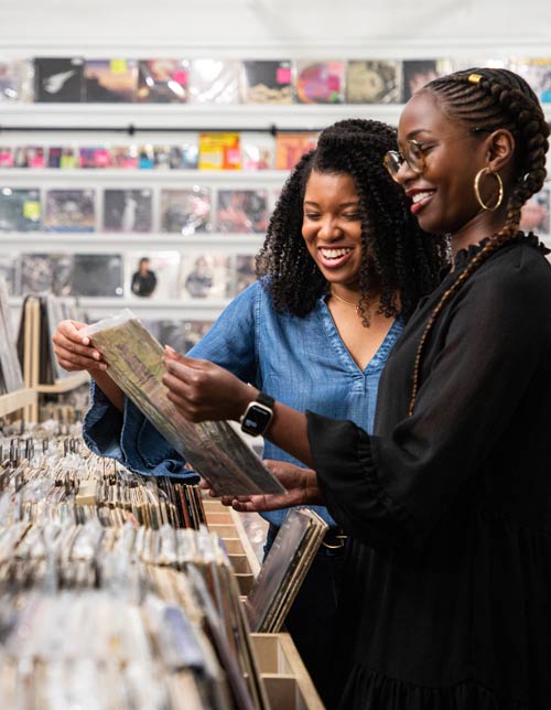 Two women shopping at record store